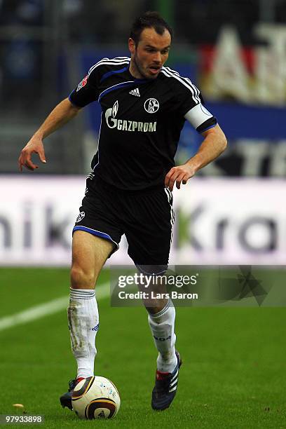 Heiko Westermann of Schalke runs with the ball during the Bundesliga match between Hamburger SV and FC Schalke 04 at HSH Nordbank Arena on March 21,...