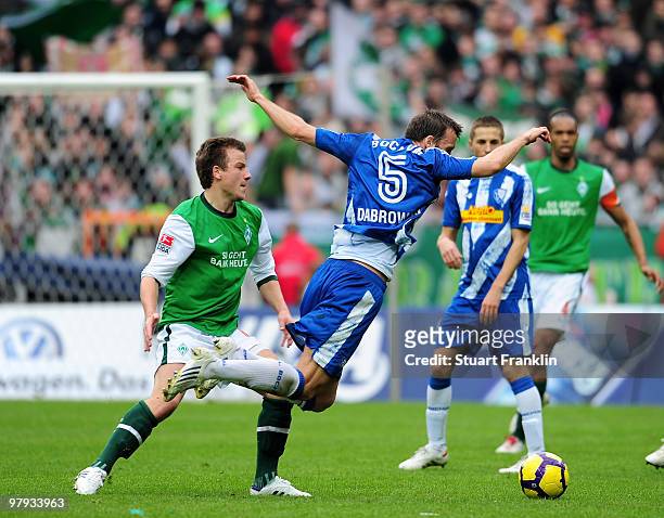 Philipp Bargfrede of Bremen is challenged by Christoph Dabrowski of Bochum during the Bundesliga match between SV Werder Bremen and VfL Bochum at...