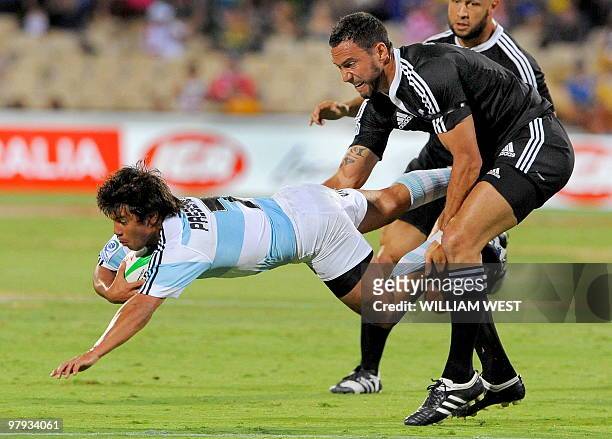 New Zealand's Zar Lawrence tackles Argentina's Omas Passerotti during their match on the second day of the Adelaide Sevens rugby union, in Adelaide...