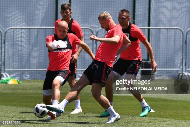 Poland's Ramil Glik and Rafal Kurzawa practice during a training session at the Sputnik sports center in Sochi on June 20, 2018 as part of Russia...