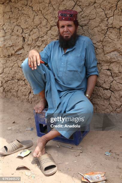 An Afghan refugee man poses for a photo at a refugee camp in a slum dwelling neighborhood on the outskirts of Islamabad, Pakistan on June 20, 2018....