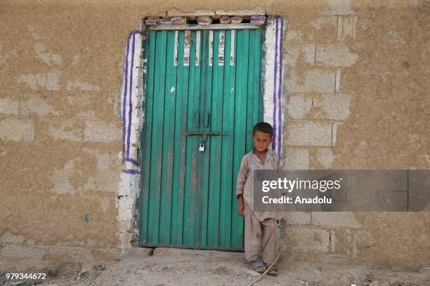 An Afghan refugee boy poses for a photo at a refugee camp in a slum dwelling neighborhood on the outskirts of Islamabad, Pakistan on June 20, 2018....