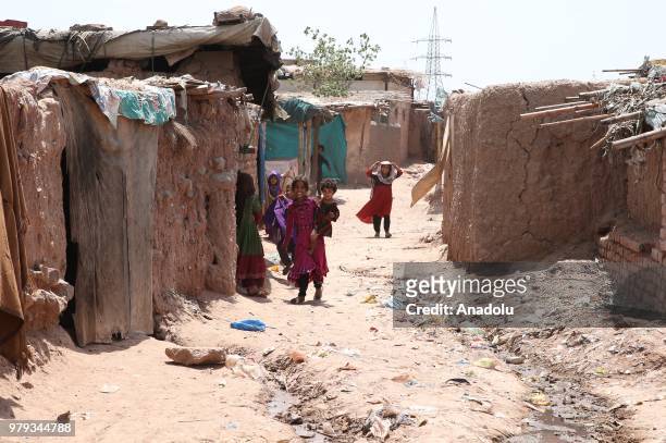 Afghan refugee children are seen at a refugee camp in a slum dwelling neighborhood on the outskirts of Islamabad, Pakistan on June 20, 2018. About...