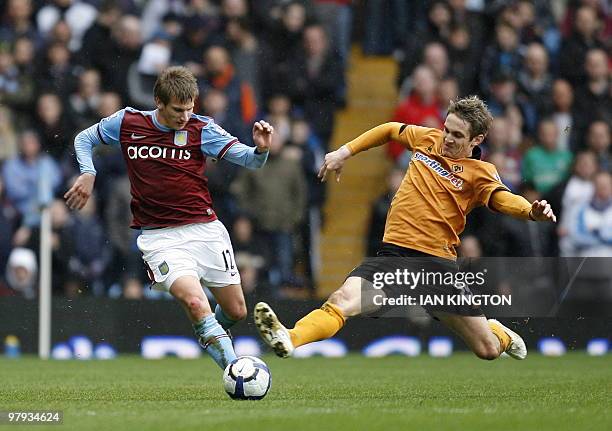 Aston Villa's English midfielder Marc Albrighton vies with Wolverhampton Wanderers' Irish striker Kevin Doyle during the English Premier League...