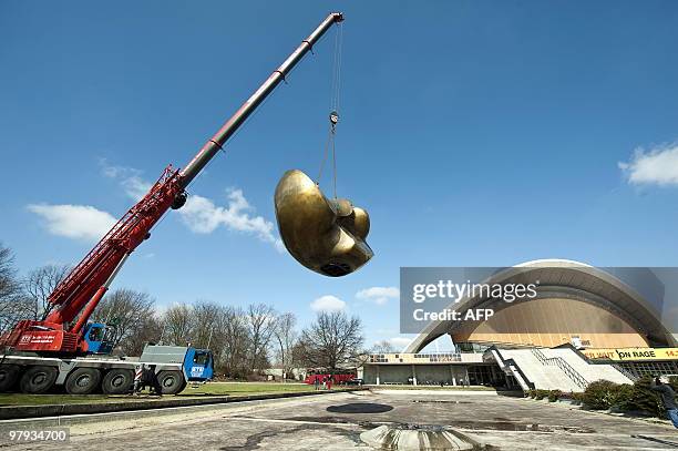 British artist Henry Moore's sculpture "Butterfly" is raised by a crane in front of the "House of World Cultures" in Berlin on March 22, 2010. The...