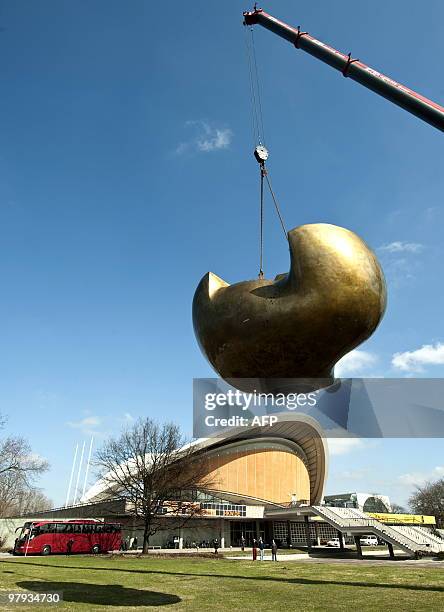 British artist Henry Moore's sculpture "Butterfly" is raised by a crane in front of the "House of World Cultures" in Berlin on March 22, 2010. The...