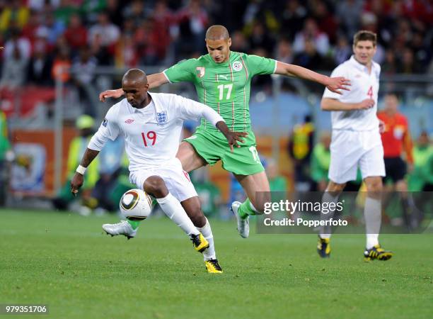 Jermain Defoe of England is challenged by Adlane Guedioura of Algeria during a FIFA World Cup Group C match at the Cape Town Stadium on June 18, 2010...