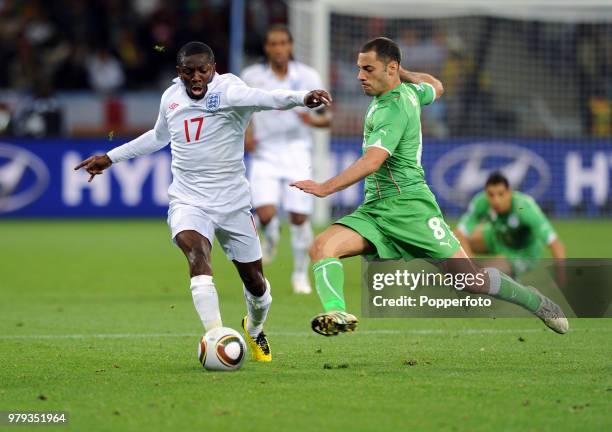 Shaun Wright-Phillips of England takes on Medhi Lacen of Algeria during a FIFA World Cup Group C match at the Cape Town Stadium on June 18, 2010 in...