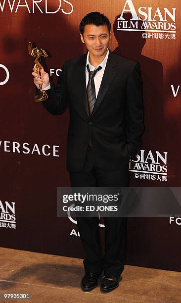 Hong Kong's Nicholas Tse poses with the best supporting actor trophy at the 4th annual Asian Film Awards presentation ceremony at the Hong Kong...
