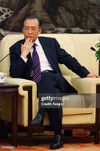 Chinese Premier Wen Jiabao listens a question during a meeting with entrepreneurs from various countries at China Development Forum at the Great Hall...