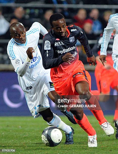 Marseille's Cameroonian midfielder Stephane M'Bia vies with Lyon's forward Sydney Govou during their French L1 match Marseille vs Lyon, on March 21,...