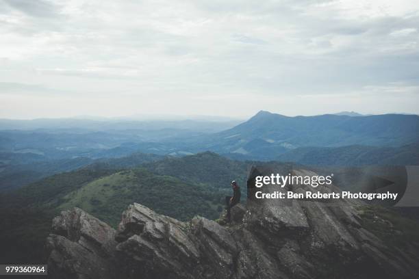 man reaching the summit of a mountain - boone north carolina stock pictures, royalty-free photos & images