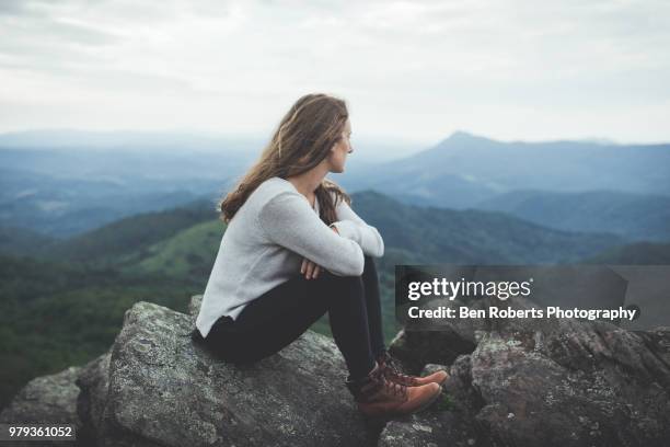 woman sits in contemplation of a beautiful mountain scene - boone north carolina stock pictures, royalty-free photos & images