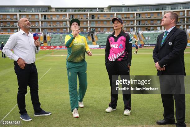 Mark Butcher and Match Referee Phil Whitticase oversee the coin toss between Suzie Bates of New Zealand and Dane Van Niekerk of South Africa during...