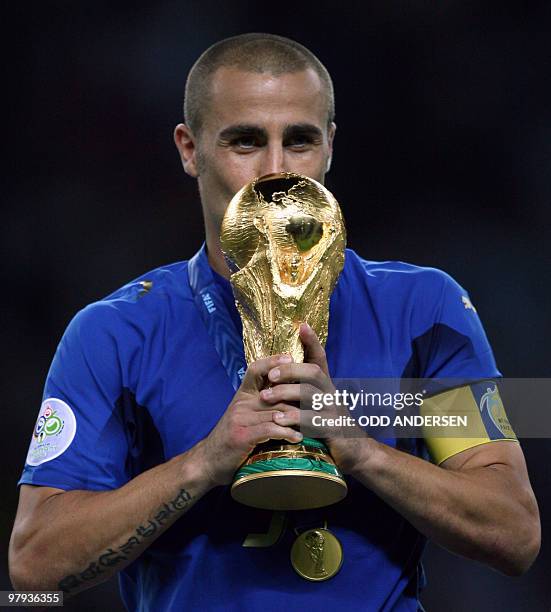 Italian captain Fabio Cannavaro kisses the World Cup trophy, 09 July 2006 at Berlin stadium. Italy won the World Cup final on penalties Sunday after...