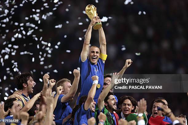 Italian defender Fabio Cannavaro celebrates with the trophy after the World Cup 2006 final football game Italy vs.France, 09 July 2006 at Berlin...