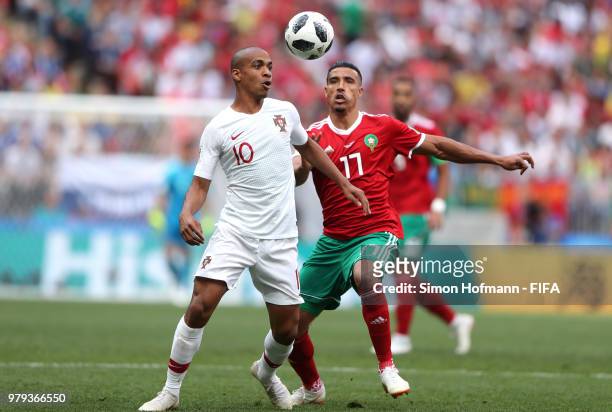 Joao Mario of Portugal is tackled by Nabil Dirar of Morocco during the 2018 FIFA World Cup Russia group B match between Portugal and Morocco at...