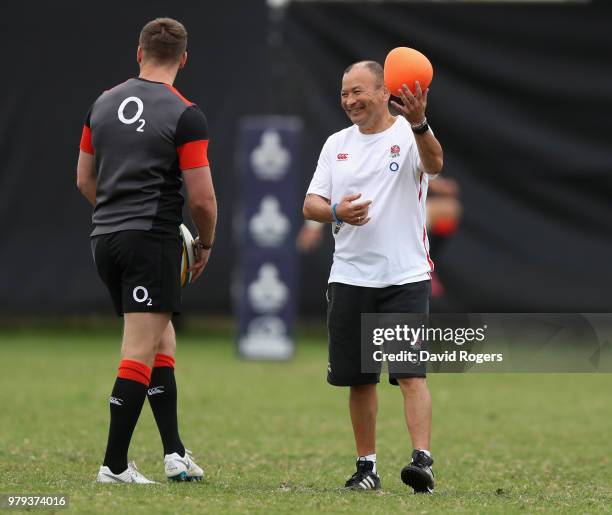 Eddie Jones, the England head coach smiles watched by Owen Farrell during the England training session at Kings Park on June 20, 2018 in Durban,...