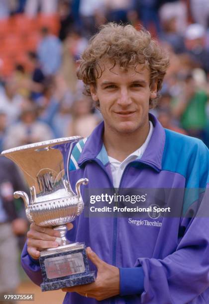Mats Wilander of Sweden poses with the trophy after defeating Martin Jaite of Argentina in the Men's Singles Final of the Italian Open Tennis...