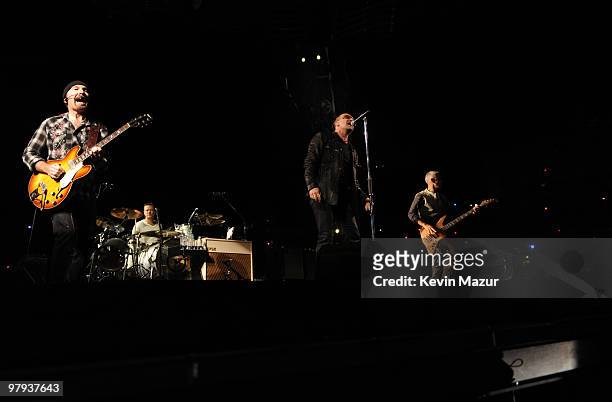 The Edge, Bono, Larry Mullen Jr and Adam Clayton of U2 perform at Rose Bowl during their U2 360 Tour on October 25, 2009 in Pasadena, California.