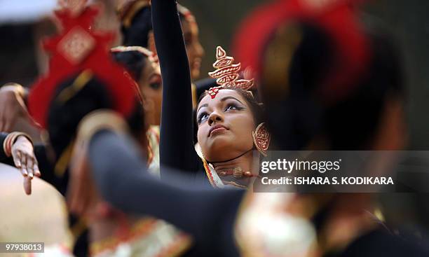 Sri Lankan dancers perform a traditional low country Gajaba Vannama dance routine to foreign visitors at the Udawalawe nature reserve in the southern...