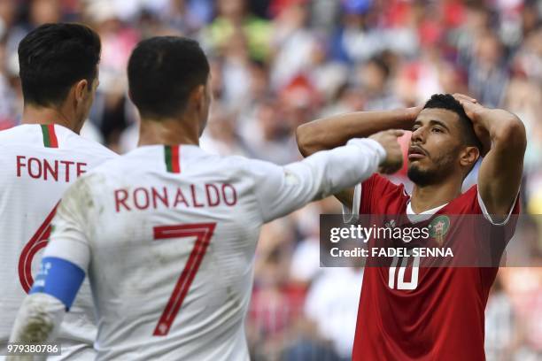 Portugal's forward Cristiano Ronaldo gestures next to Morocco's midfielder Younes Belhanda reacting during the Russia 2018 World Cup Group B football...