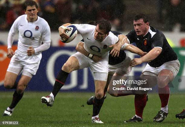 Mark Cueto of England is tackled by Thomas Domingo of France during the RBS Six Nations Championship match between France and England at the Stade de...