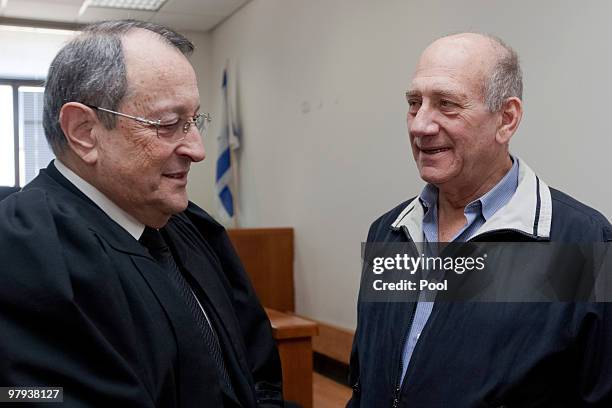 Former Israeli Prime Minister Ehud Olmert speaks with his attorney during his trial at the District Court on March 22, 2010 in Jerusalem, Israel....