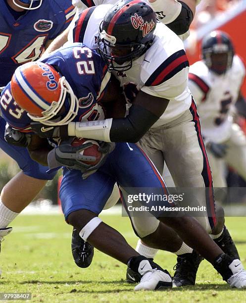 Florida wide receiver Carlos Perez drives for tough yardage against Ole Miss defensive lineman Josh Cooper Saturday, October 4, 2003 at Ben Hill...