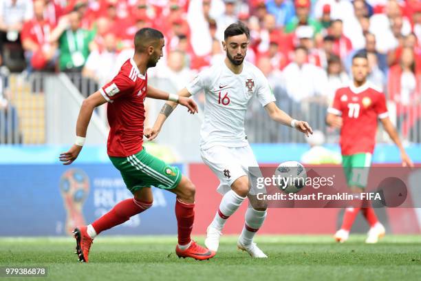 Bruno Fernandes of Portugal is challenged by Hakim Ziyach of Morocco during the 2018 FIFA World Cup Russia group B match between Portugal and Morocco...