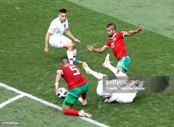 Cristiano Ronaldo of Portugal is fouled by Mehdi Benatia of Morocco just outside the box during the 2018 FIFA World Cup Russia group B match between...