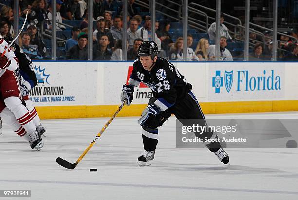 Martin St. Louis of the Tampa Bay Lightning skates up ice with the puck against the Phoenix Coyotes at the St. Pete Times Forum on March 16, 2010 in...