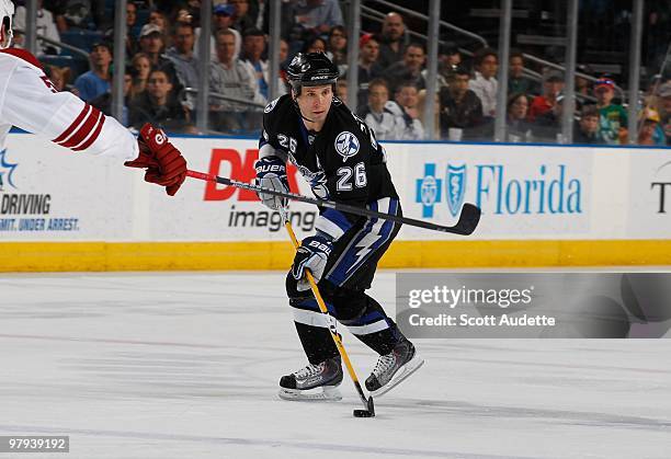 Martin St. Louis of the Tampa Bay Lightning controls the puck against the Phoenix Coyotes at the St. Pete Times Forum on March 16, 2010 in Tampa,...