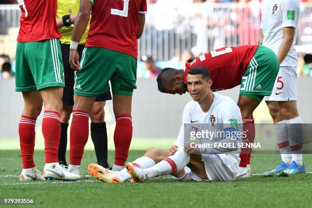 Portugal's forward Cristiano Ronaldo pulls his socks up after falling during the Russia 2018 World Cup Group B football match between Portugal and...