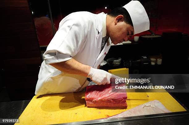 Sushi chef William Tawng prepares sushi and sashimi from a bluefin tuna at the upscale Japanese restaurant Megu in New York on March 10, 2010. The...