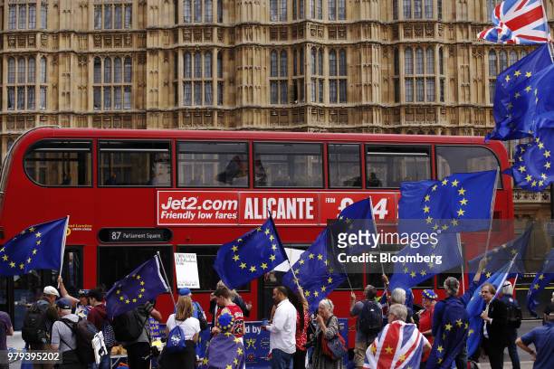 Pro-European Union and anti Brexit demonstrators wave European Union flags outside the Houses of Parliament in London, U.K., on Wednesday, June 20,...