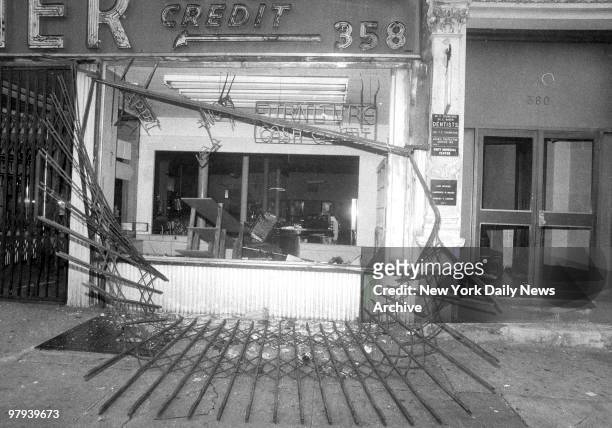 Protective gate in front of store on Broadway between 145th and 165th Sts. Lies twisted on the street after looting during 1977 blackout power...