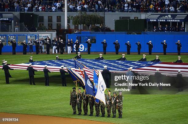 Color guard presents the flag before start of Game 2 of the American League Division Series between the New York Yankees and the Oakland Athletics at...