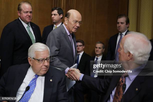 Secretary of Commerce Wilbur Ross greets Sen. John Cornyn and Sen. Mike Enzi before a hearing of the Senate Finance Committee in the Dirksen Senate...