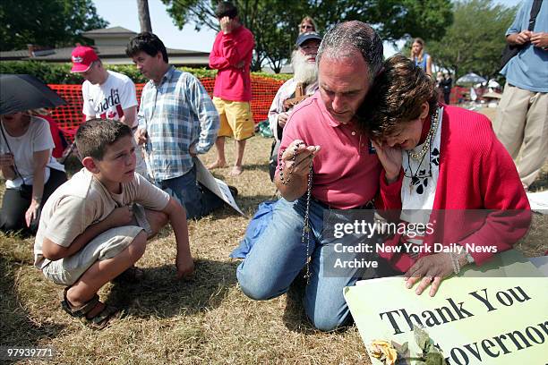 Protesters pray outside the Woodside Hospice in Pinellas Park, Fla., where Terri Schiavo died this morning, 13 days after her feeding tube was...