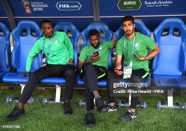 Mohammed Alsahlawi, Mansour Alharbi and Mohammed Alburayk of Saudi Arabia look on from the bench the 2018 FIFA World Cup Russia group A match between...