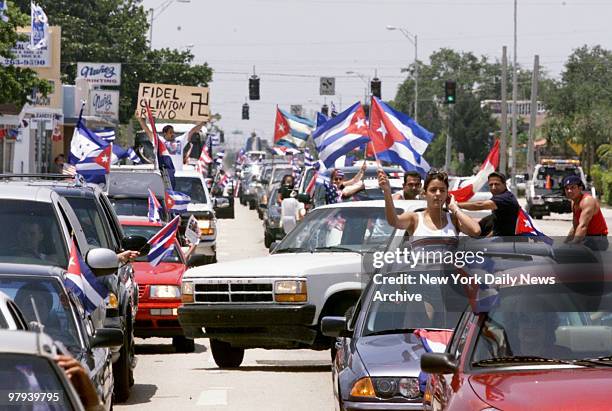 Protesters wave flags from cars and clog the streets to protest the taking of Elian Gonzalez by the INS during a pre-dawn raid on his relatives' home.