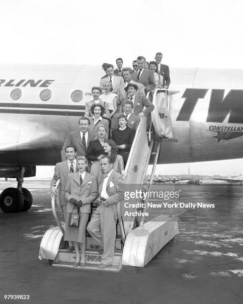 Protesting the methods of the House Un-American Activities Committee, Hollywood stars arrive on TWA Constellation at LaGuardia Field from Washington....