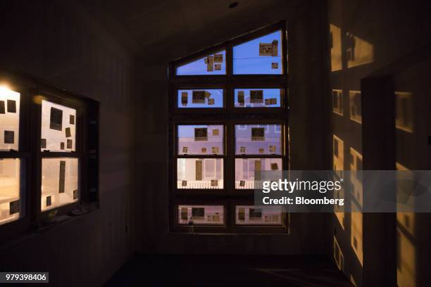 Light shines through hurricane-rated windows during construction of a home designed to withstand extreme weather in the Breezy Point neighborhood of...