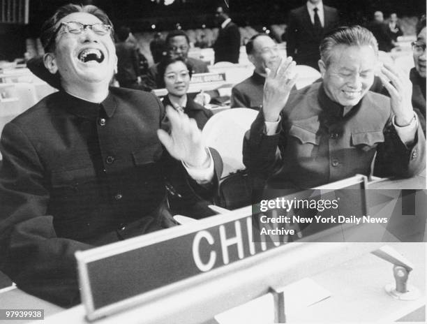 China's Foreign Minister Chiae Kuan-Hua and United Nations representative Huang Hua laugh as they take their seats at the UN General Assembly for the...