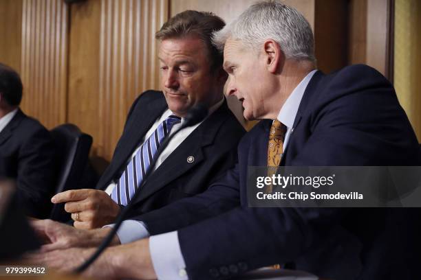 Senate Finance Committee members Sen. Dean Heller and Sen. Bill Cassidy talk as U.S. Secretary of Commerce Wilbur Ross testifies before the committee...