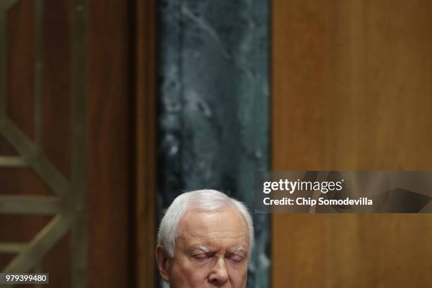 Senate Finance Committee Chairman Orrin Hatch closes his eyes as U.S. Secretary of Commerce Wilbur Ross answers Hatch's question with a list numbers...