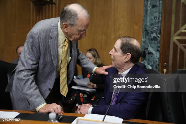 Senate Finance Committee member Sen. Charles Grassley talks with committee ranking member Sen. Ron Wyden before a hearing with U.S. Secretary of...