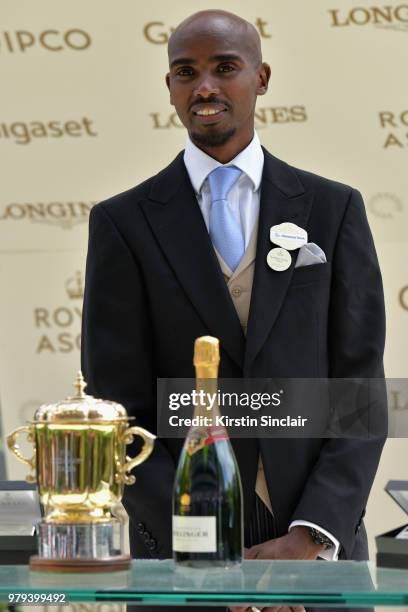 Sir Mo Farah presents The Queen Mary Stakes trophy on day 2 of Royal Ascot at Ascot Racecourse on June 20, 2018 in Ascot, England.