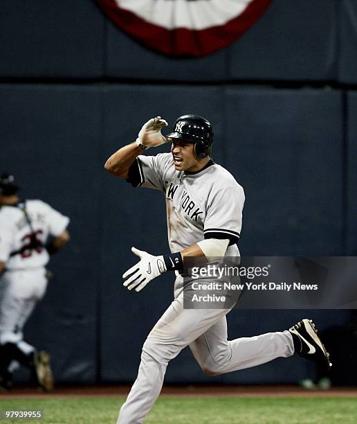 York Yankees' Alex Rodriguez celebrates as he crosses home plate with the winning run in the 11th inning of Game 4 of the American League Division...